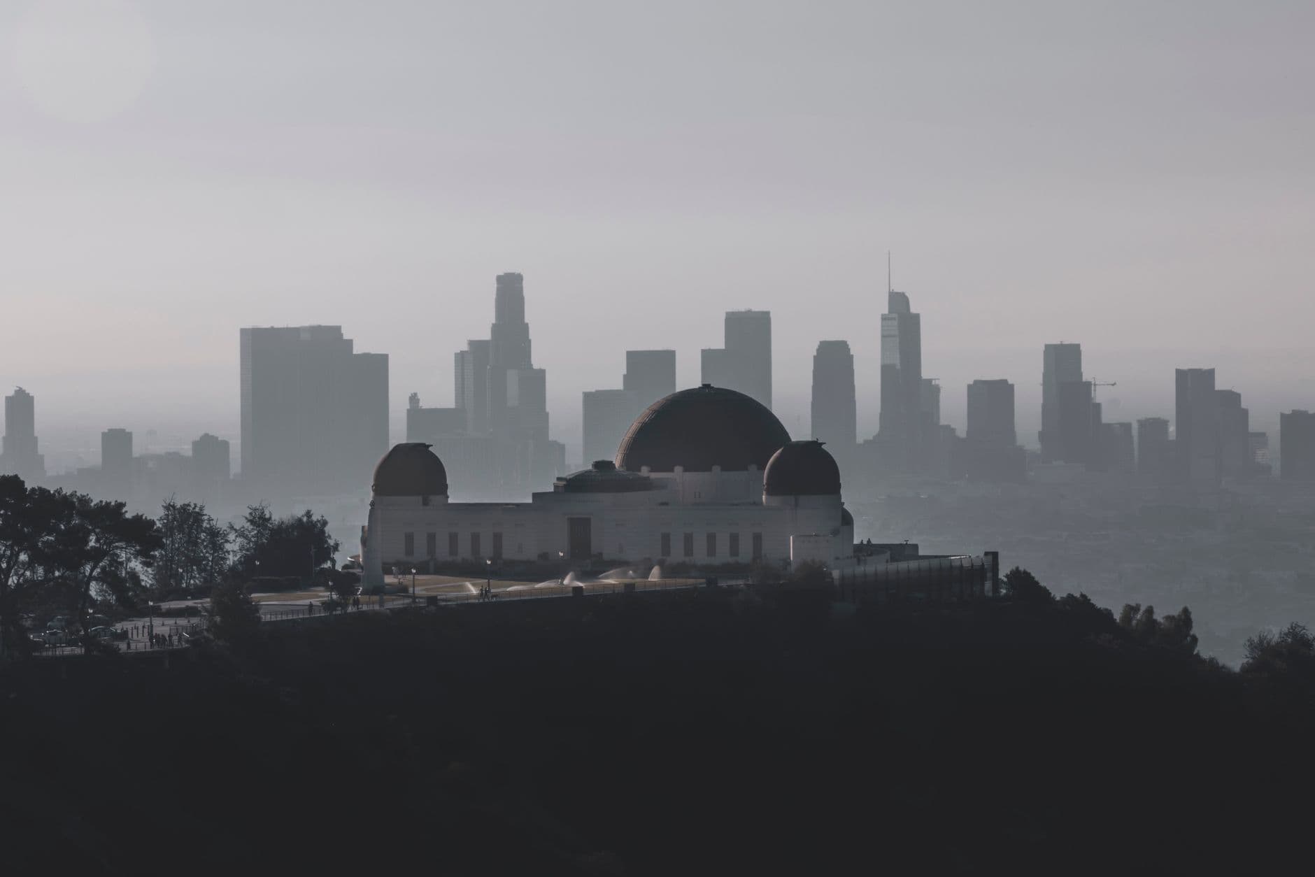 Griffith Observatory with Los Angeles skyline in the background during a hazy day.