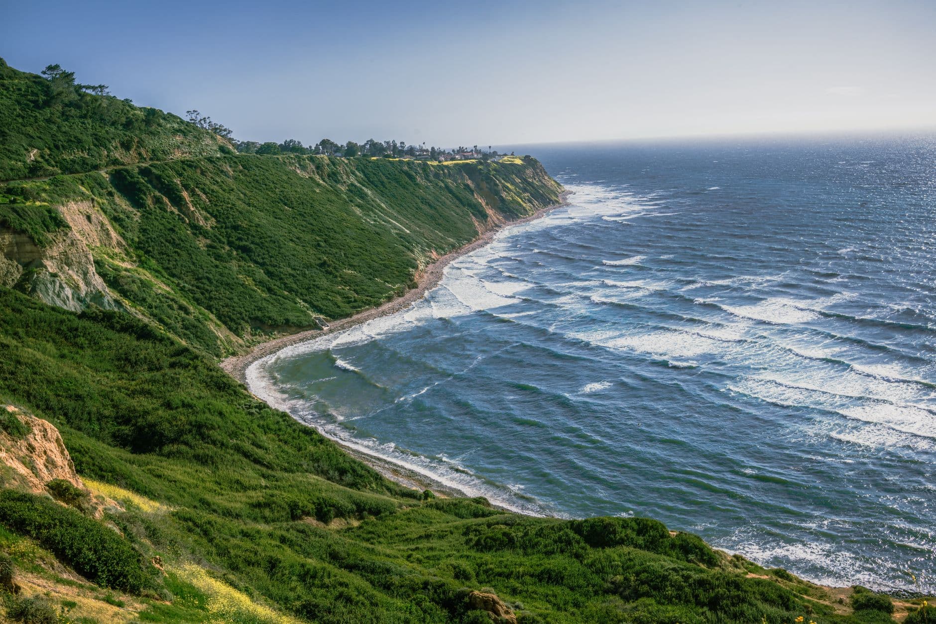 Breathtaking view of rocky cliffs meeting the ocean at daytime.